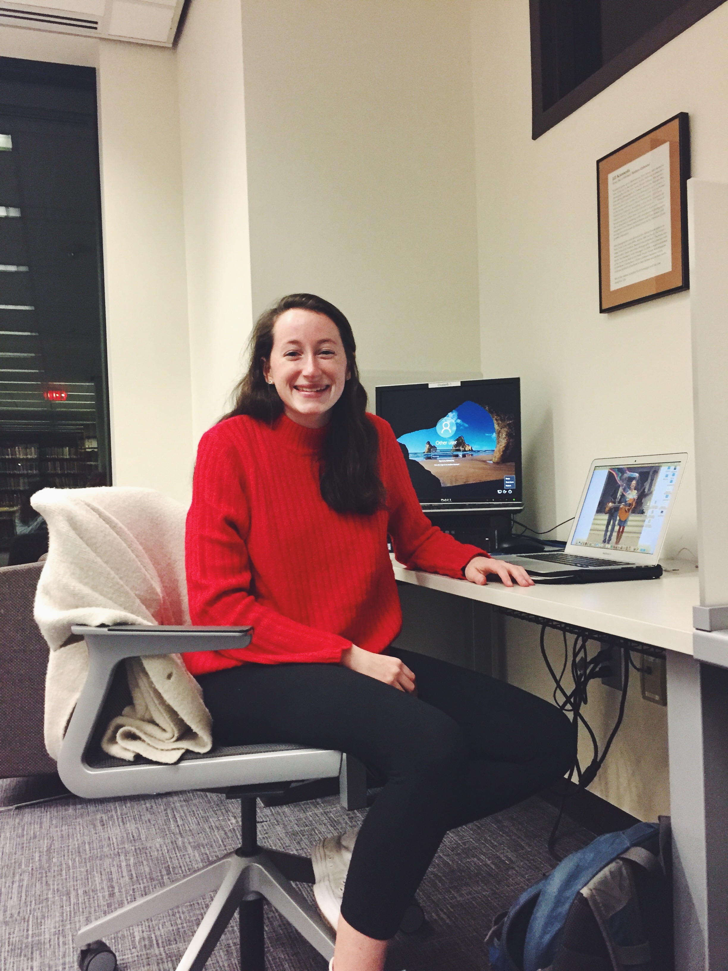 Avery Lowe sitting in her nook with her computer in the library 