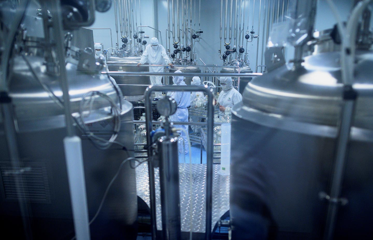 Image of scientist working in a lab with hazmat suits on