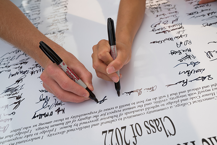 Students sign the honor pledge. 