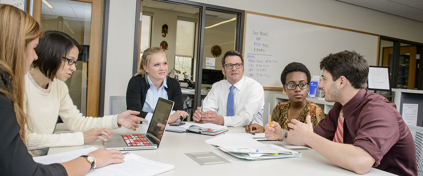 Students and ARC staff talk around a conference table