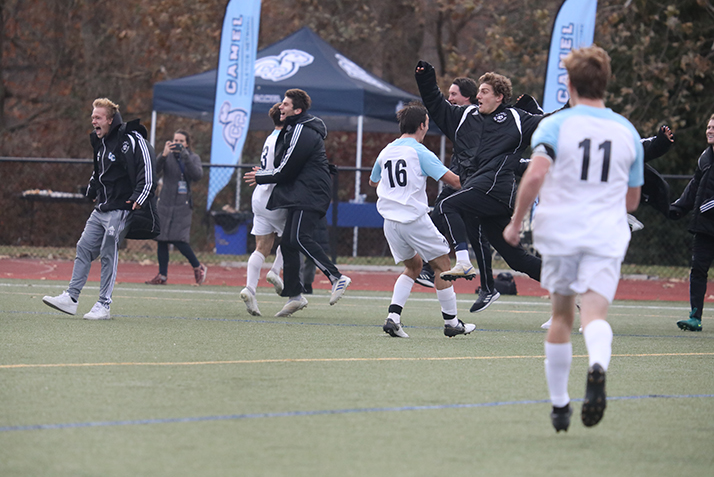 Players and coaches celebrate as Conn wins in overtime. 