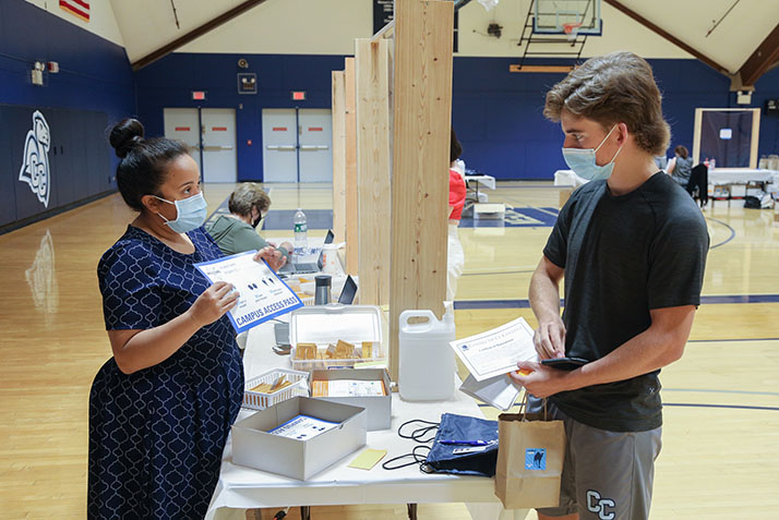 A student receives his campus access pass