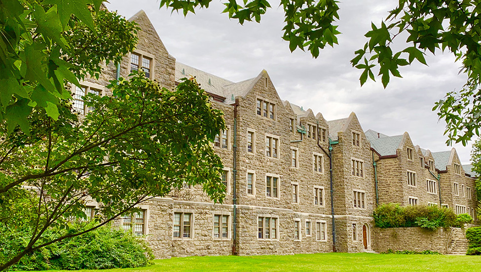 A Connecticut College residence hall framed by foliage