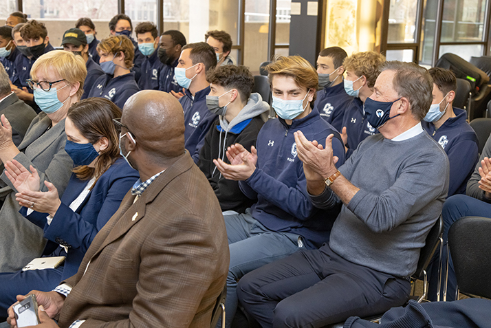 Governor Lamont sits with members of the team during the formal remarks. 