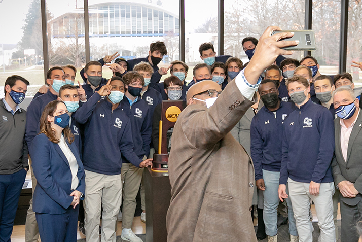 Representative Nolan takes a selfie with the NCAA Division III national champions, President Bergeron, Governor Lamont, and others. 