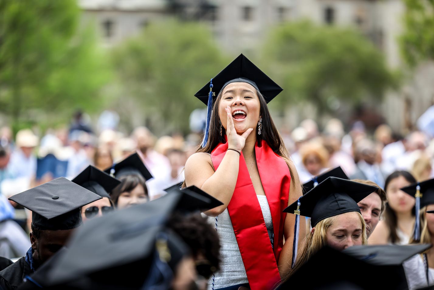 A graduate cheers on a friend