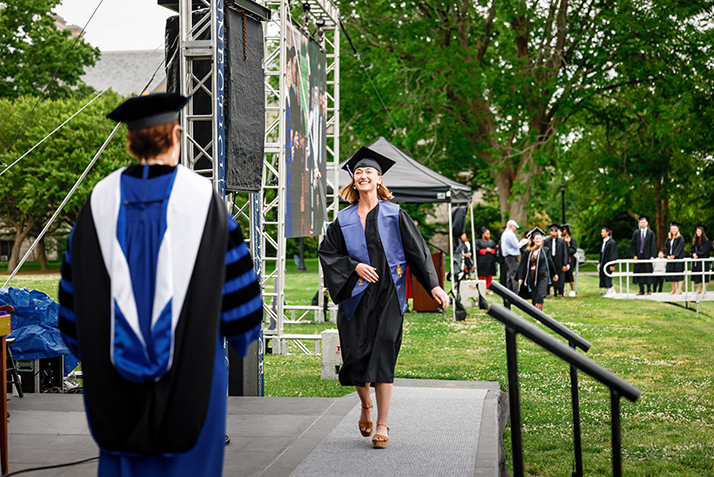 A graduate crosses the stage.