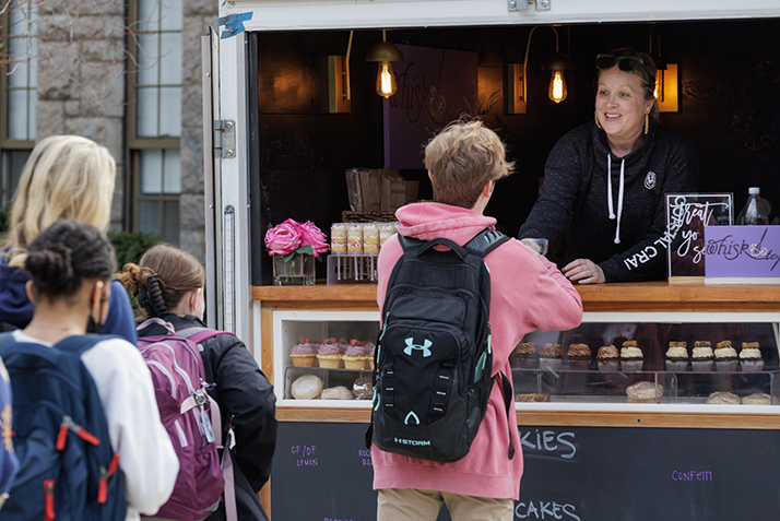 Treats are handed out at a food truck.