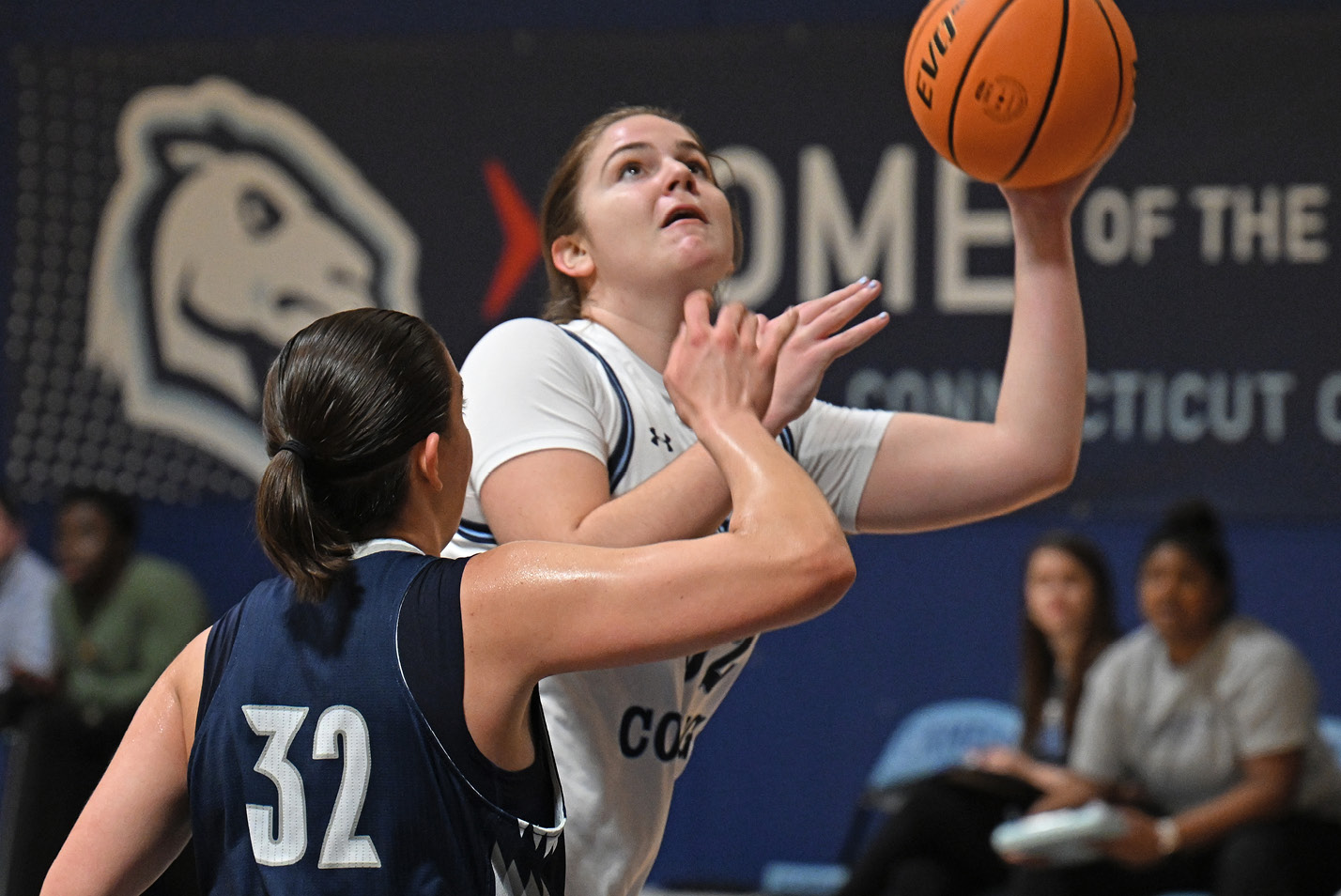 Women's basketball player goes up for a layup