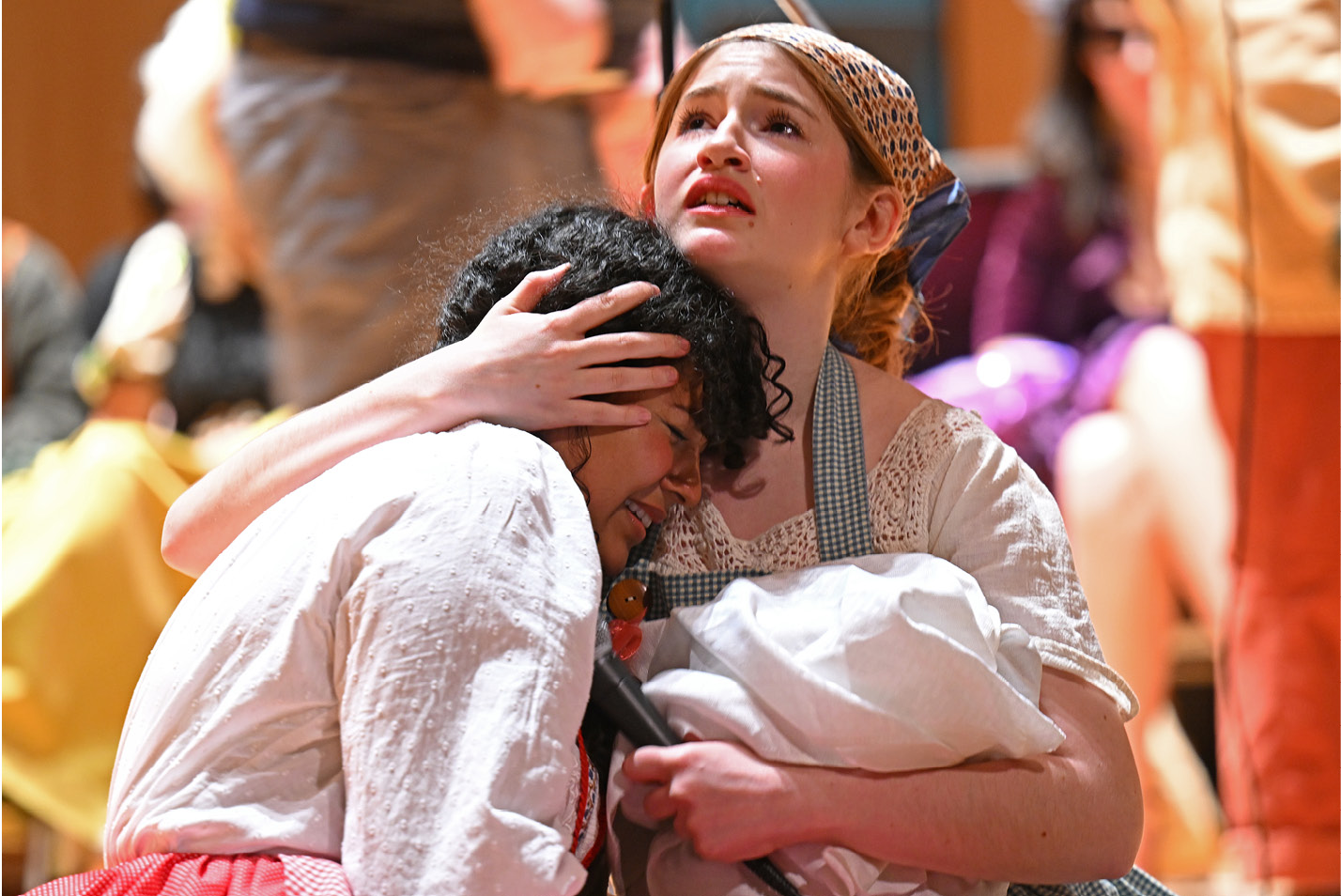 Two actors cling to each other during the theater department's “Into the Woods” concert Friday, March 31, 2023 in Evans Hall.