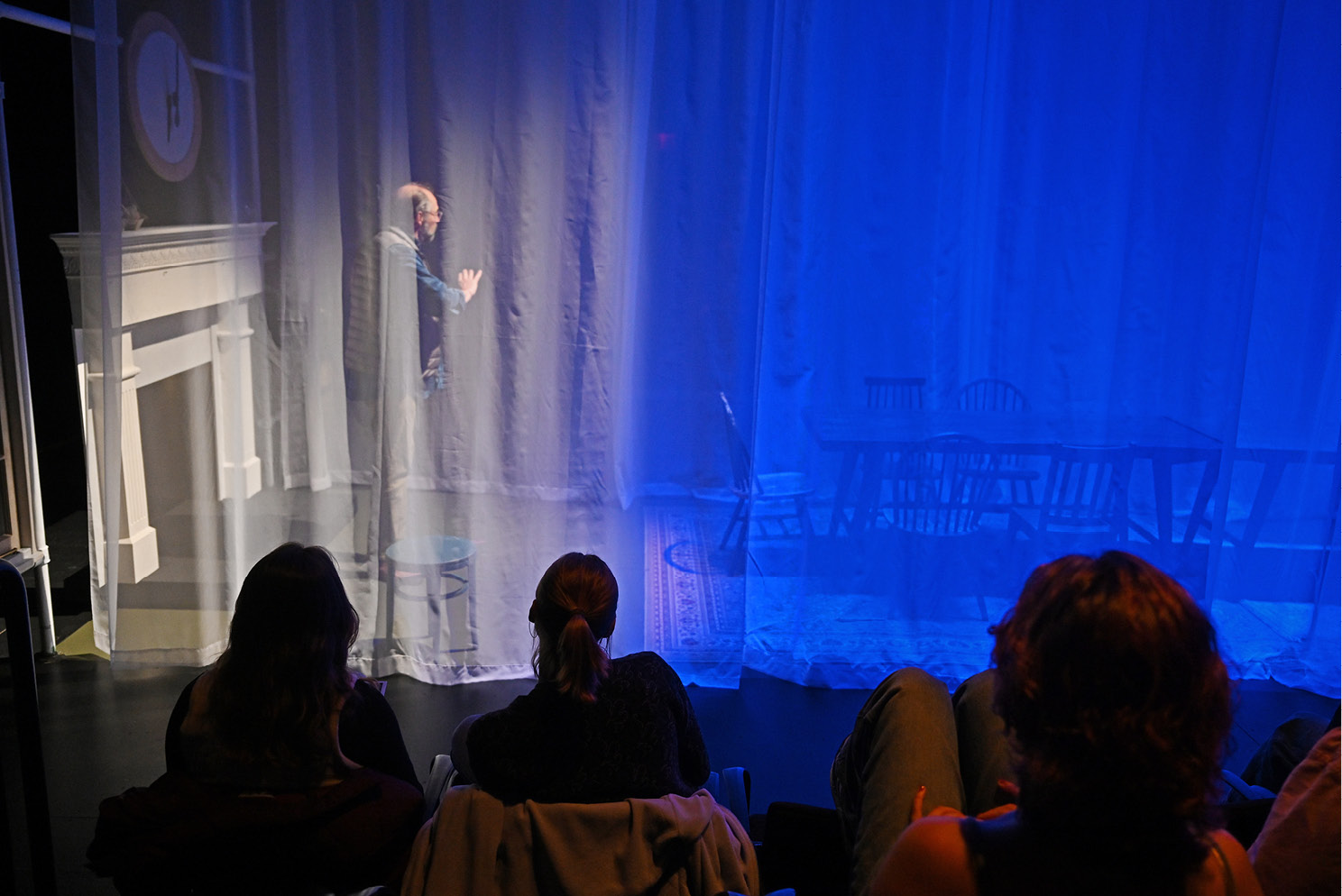 Audience looking through a curtain