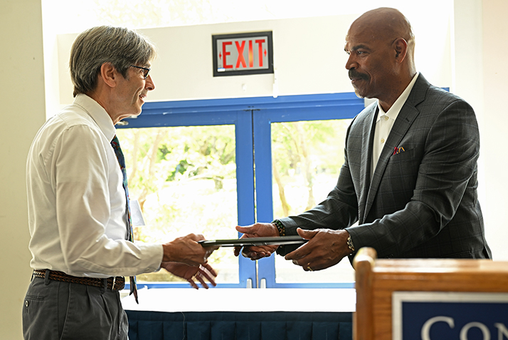 Doug Dole accept his award from VP Reginald White