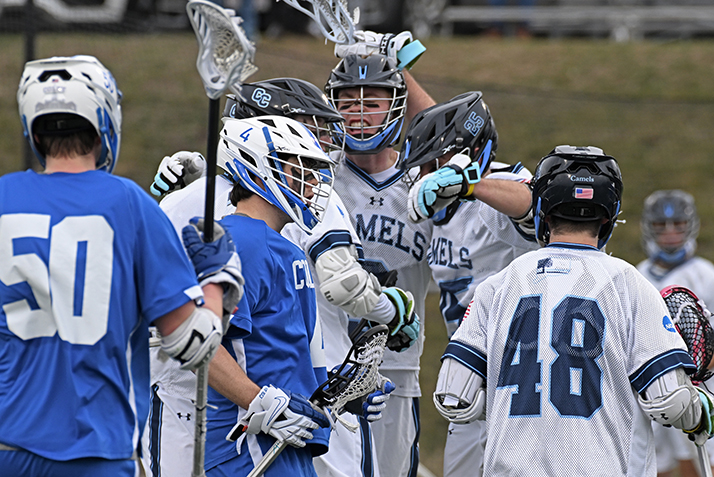 lacrosse players celebrate a goal