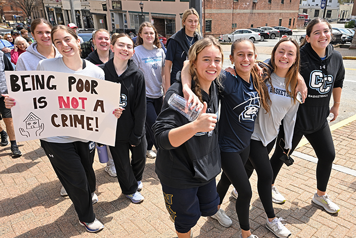 student smile as they march in a community event