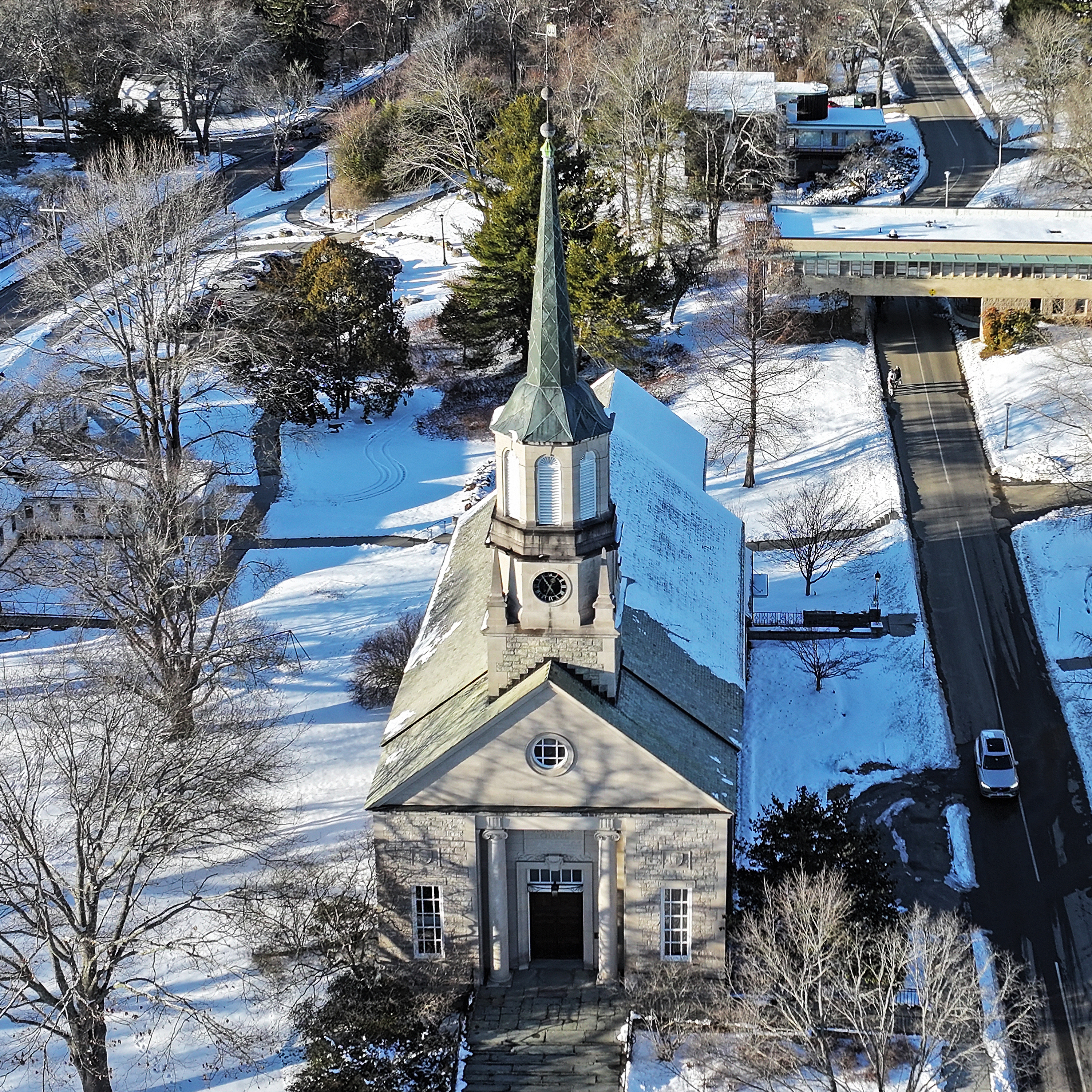 Aerial view of college chapel blanketed in snow.